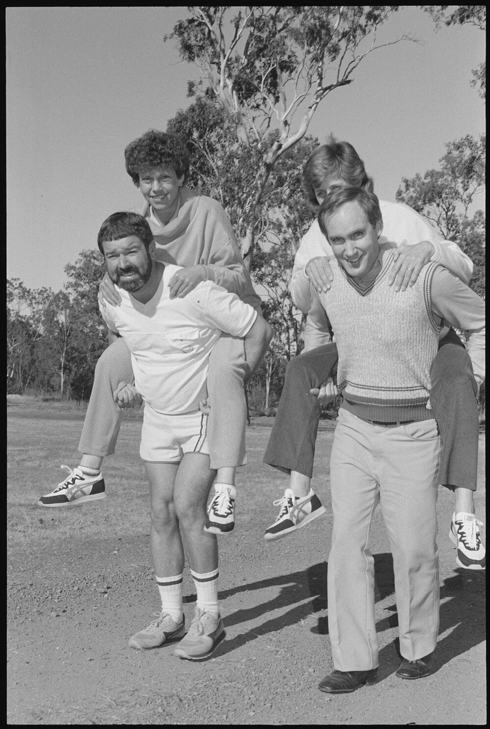 Two unidentified couples getting a piggyback ride from their partners, Ipswich, July 1985