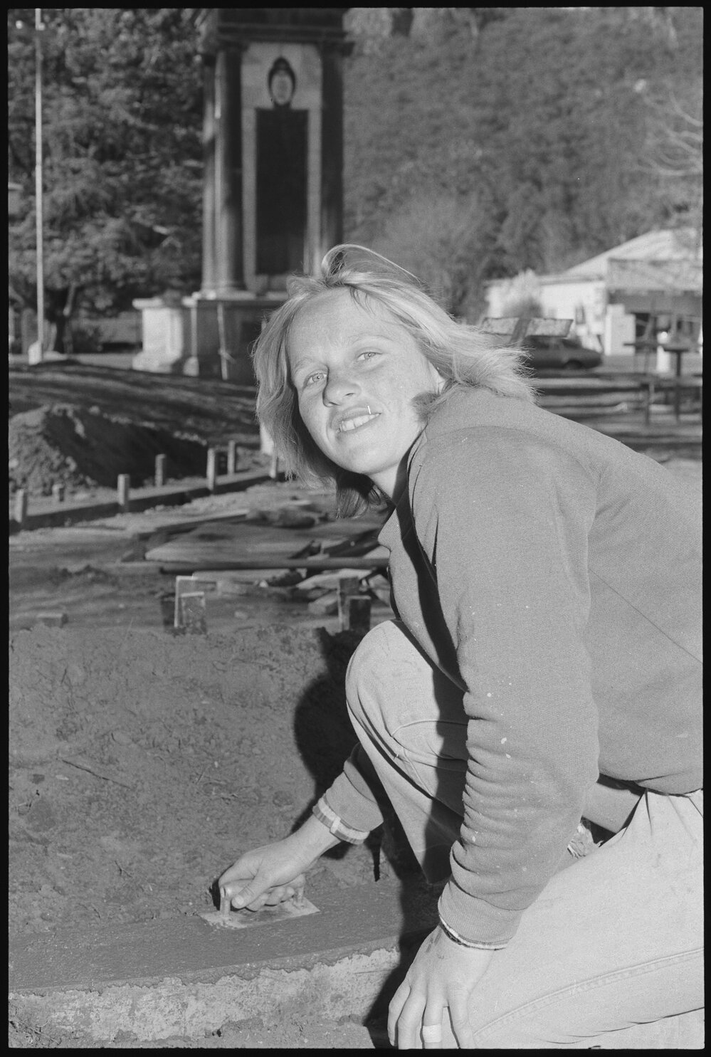 Unidentified woman laying concrete slab, Ipswich, July 1985