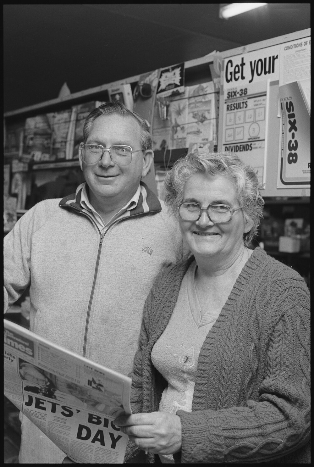 Unidentified couple holding a newspaper, Ipswich, July 1985