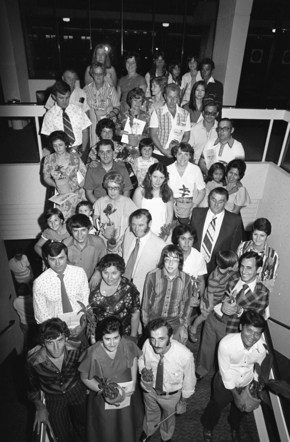Immigrants receiving Australian citizenship and a plant, Ipswich, November 1977