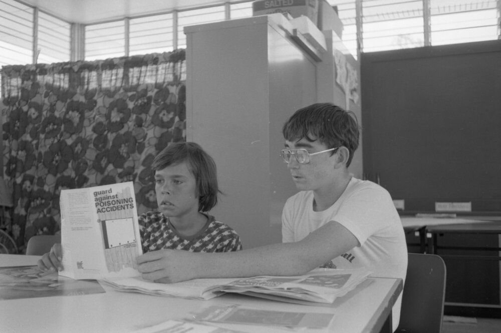 Children reading a brochure about poisoning accidents, Ipswich, November 1977