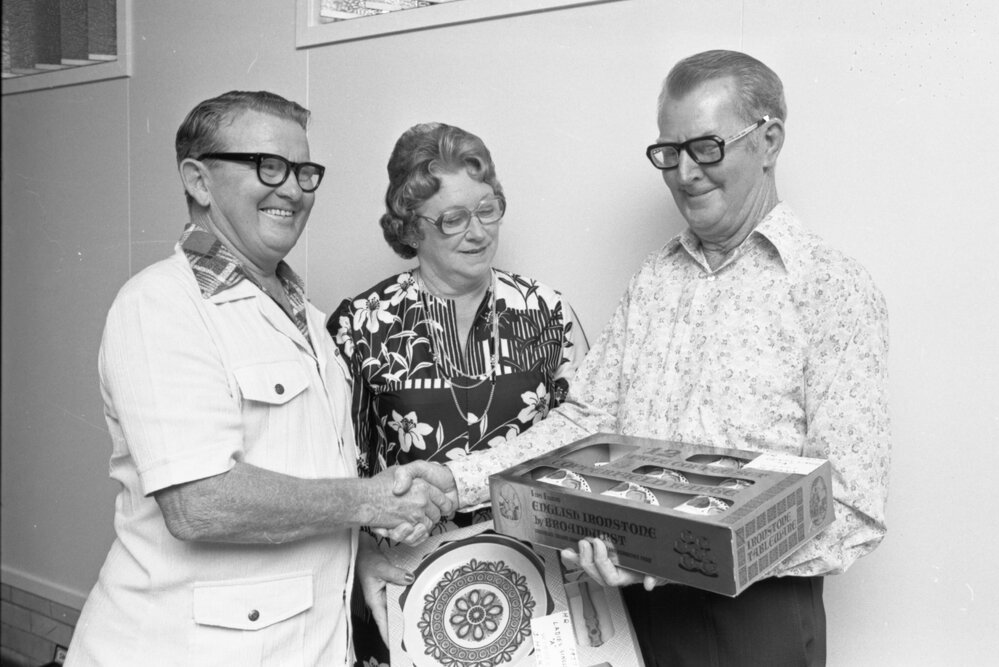 Unidentified people holding crockery sets, Ipswich, November 1977