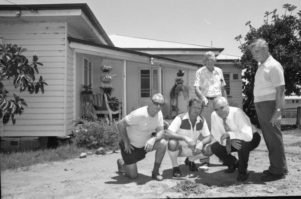 Ron Camm and Stanley Hayes with unidentified men outside a timber house, Ipswich, February 1978