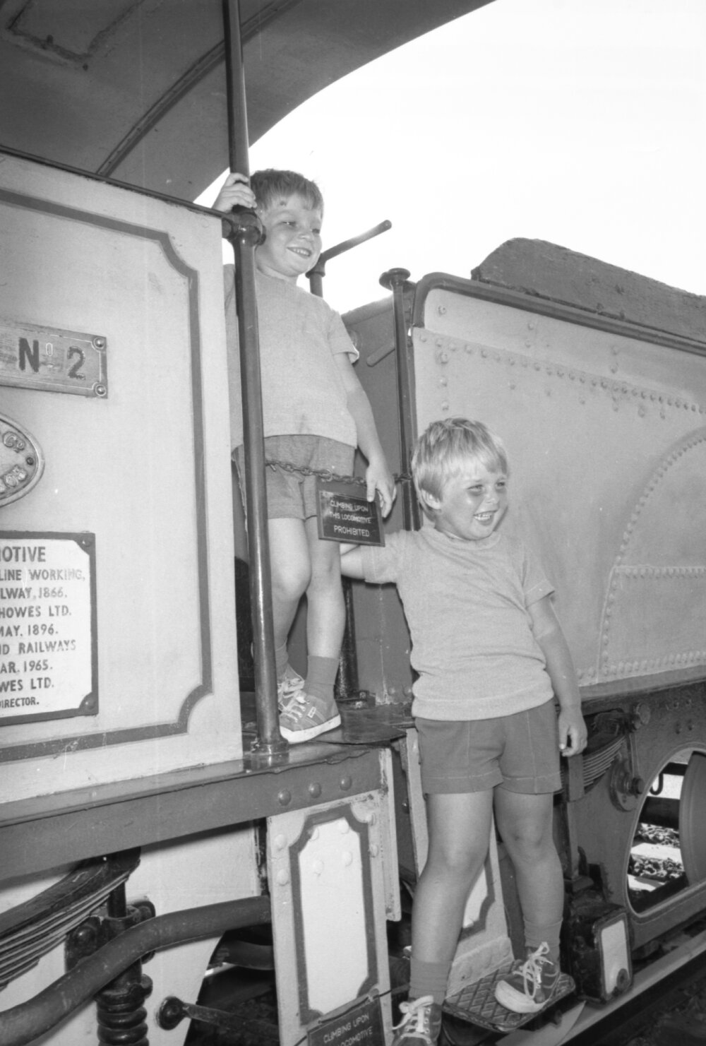 Two unidentified boys playing on a display train, Ipswich, Queensland, February 1978
