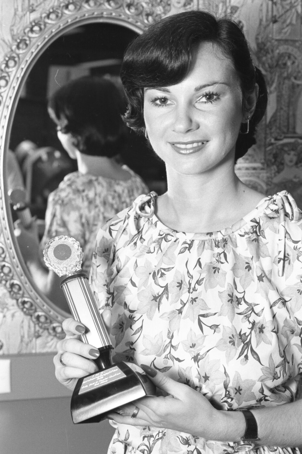 Unidentified hairdresser displays her award, Ipswich, February 1978