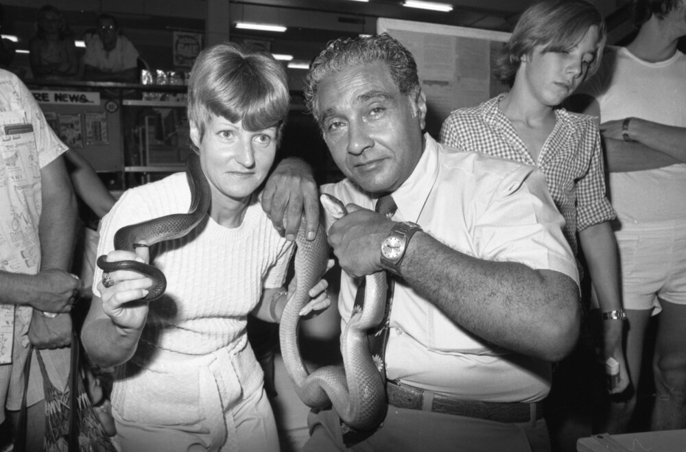 Ram Chandra poses with snake and unidentified member of the audience during Snake Demonstration at Reid's Department Store, Ipswich, February 1978