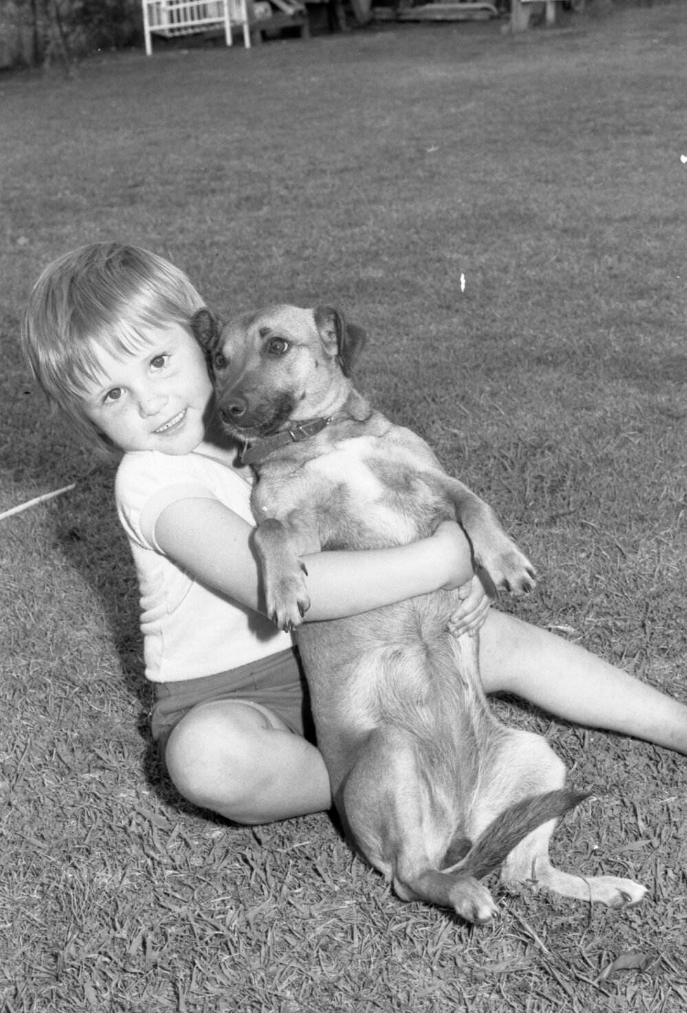 Troy Preston playing with his dog, Tina, Ipswich, 7th October 1977