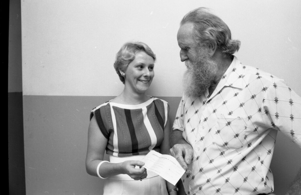 Frank Ryder of the Ipswich Beardies presenting an unidentified young woman with a cheque, Ipswich, 22nd March 1977