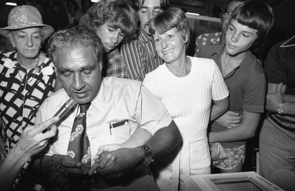 Ram Chandra demonstrates snake bite on unidentified member of the audience during Snake Show at Reid's Department Store, Ipswich, February 1978