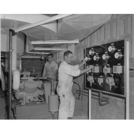 Ipswich Bowling Alley staff with air-conditioning unit, corner Brisbane and Thorn Streets, Ipswich, 1963