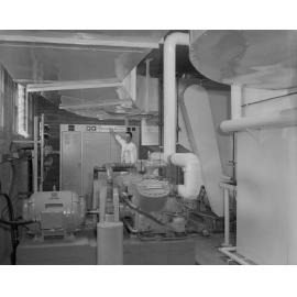 Ipswich Bowling Alley staff member with air-conditioning unit, corner Brisbane and Limestone Streets, Ipswich, 1963