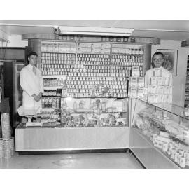 Staff with Nolans Pharmacy Baby Products display, corner of Brisbane and Nicholas Streets, Ipswich, 1955