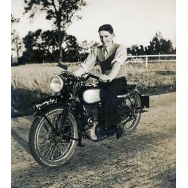 Unidentified rider on a Royal Enfield motorbike, in Rosewood, c.1950