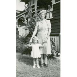 Mother and daughter in front of home at 12 Delacey Street, North Ipswich, 1946