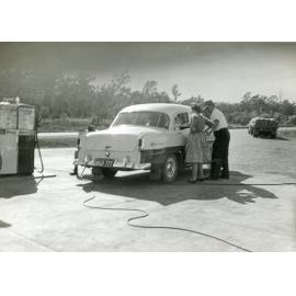 Holden car in front of petrol pump at the Blue Star Service Station, Warrego Highway,Blacksoil, Ipswich, 1958