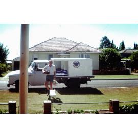 Denis Dargusch beside his milk truck, Silkstone, Ipswich|Ipswich, Queensland, early 1960s
