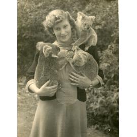 Phyllis Mander (nee Brown) with koalas, thought to be at Lone Pine Sanctuary, Fig Tree Pocket, Brisbane, mid 1940s
