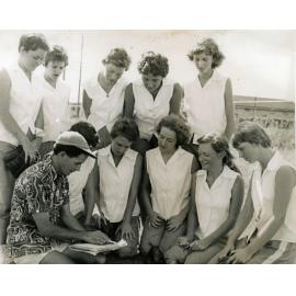 Rocket's Softball Team in discussion with Coach, John Walker, East Ipswich Hockey Grounds, Ipswich, 1955-1956