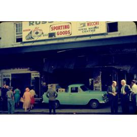 Shoppers and onlookers in at the  aftermath of fire at Russ Dore Mercury Centre Showroom, Brisbane Street, Ipswich, 1963