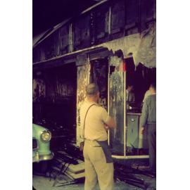 Workers at the aftermath of fire at Russ Dore Mercury Centre Showroom, Brisbane Street, Ipswich, 1963
