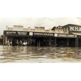 Men standing in flood water, Brisbane Street, Ipswich, c.1931