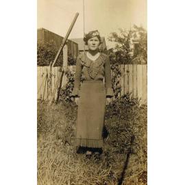 Thought to be Elizaeth Hazel Dobbie, in backyard of home, Booval, Ipswich, c.1920s