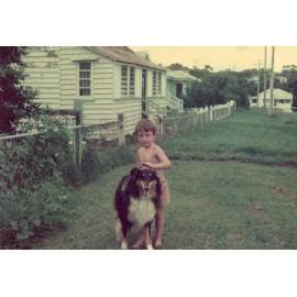 Young boy with dog in front of home in England Street, East Ipswich, 1943