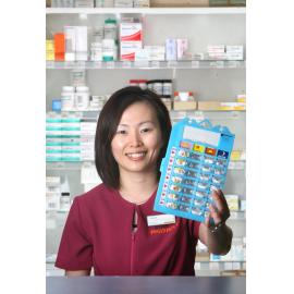 Pharmacist Pauline Ng with the new medication distribution tool for old people, January 2008