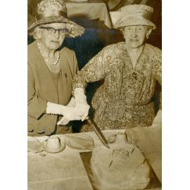 Sarah Catherine Thorn and Mrs Mills cutting Cambrian Choir birthday cake, c.1963