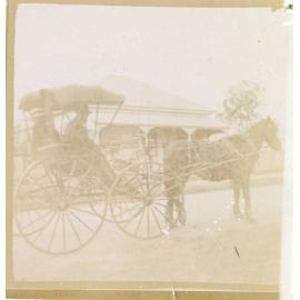 Couple in horse-drawn drop-front Phaeton in front of Ipswich residence, c.1900-1905