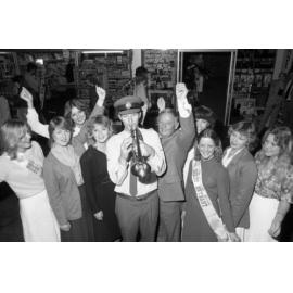Mayor Freeman with Quest Entrant in crowd around trumpeter from Ipswich Vice-Regal Model Band, Ipswich Colour Festival, Ipswich, August 1980