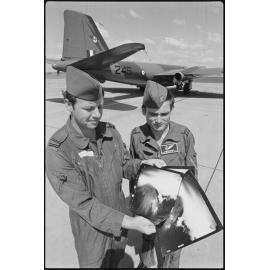 Two airmen with photo prints at RAAF Base Amberley, Amberley, October 1980