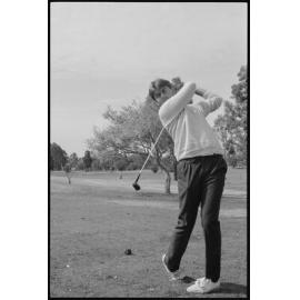 Unidentified man playing golf, location unidentified, August 1985
