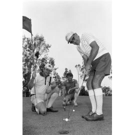 Three golfers during a putt, Ipswich, January 1978