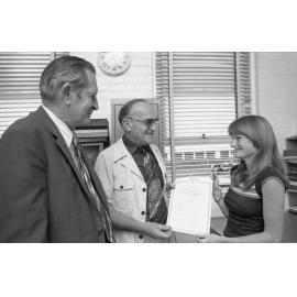 Young woman awarded a Certificate of Course Completion for an unemployment course, Ipswich, December 1977