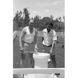 Men checking the sundial pedestal housing for the Grandchester State School Centenary Time Capsule, Grandchester, Ipswich, Queensland, January 1978
