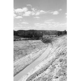 Excavators opening a water channel during the construction of Wivenhoe Dam, Lake Wivenhoe, Somerset, Queensland, January 1978