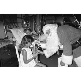 Santa handing out gifts to kids at Ipswich General Hospital, Ipswich, December 1977