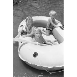 Kids on an inflatable raft at Colleges Crossing, Chuwar, December 1977