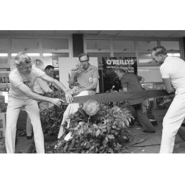 Unidentified MC overseeing long saw demonstration with Mayor Hastings at Booval fair, Booval, Ipswich, February 1978