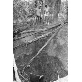 Unidentified men standing over mining shaft, Ipswich, Queensland, February 1978