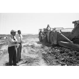 Premier Joh Bjelke-Petersen and unidentified man oversee construction of Wivenhoe Dam, Somerset, February 1978