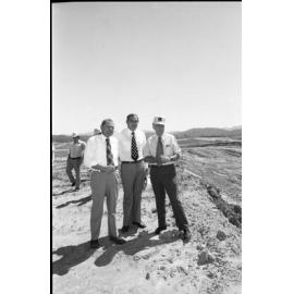 Premier Joh Bjelke-Petersen and two unidentified men at the construction site of Wivenhoe Dam, Somerset, Queensland, February 1978