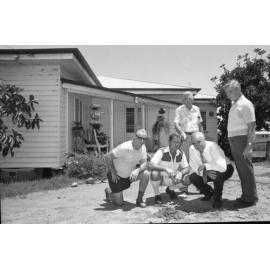 Ron Camm and Stanley Hayes with unidentified men outside a timber house, Ipswich, February 1978