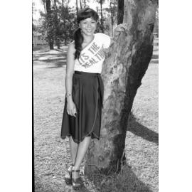 Young woman posing outdoors in text print shirt, Wacol, Brisbane, February 1978