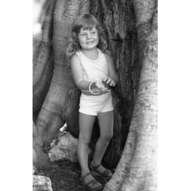 Unidentified girl posing under a large Moreton Bay fig tree in Queens Park, Ipswich, February 1978