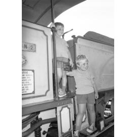 Two unidentified boys playing on a display train, Ipswich, Queensland, February 1978