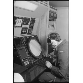 Unidentified RAAF Airman operating a control board, Ipswich, July 1985