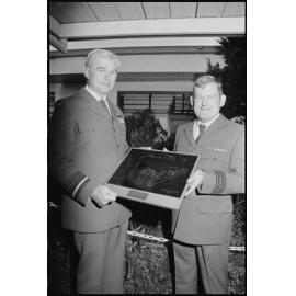 Unidentified man presenting Air Marshall John (Jake) Newham with a sketch of a RAAF Tactical Air Defence System, Ipswich, July 1985