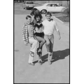 Unidentified Burlesque dancer with two men in a car park, Ipswich, July 1985
